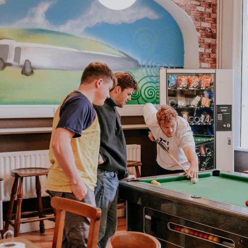 Guests playing pool at Gardiner House Hostel in Dublin